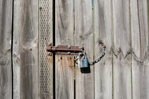 istock Padlock and rusty latch on a wooden gate 2166679189