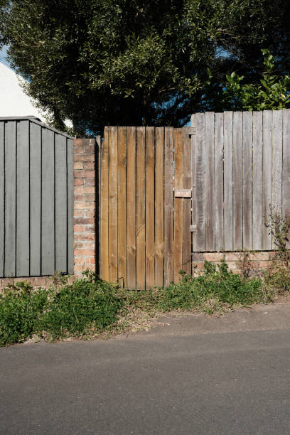 istock Brown wooden gate and gray fence 2166679190