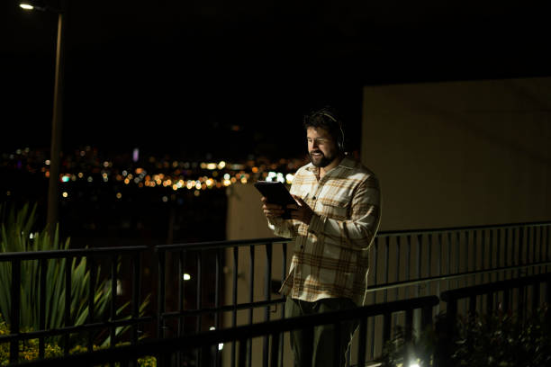 istock Man walks through the city at night while having a video call 2166684714