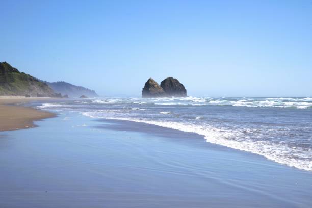 istock Massive rock formations breaking up the horizon along the beach 2166686477
