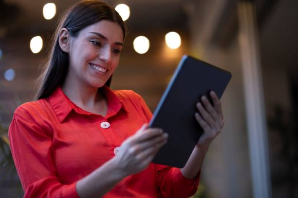 istock Woman checking her electronic device at night 2166690592