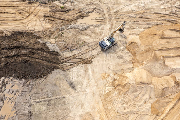 istock excavator on earthworks at construction site. heavy construction machine. aerial view. 2166691813
