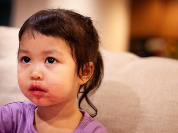 istock Toddler with smeared lipstick looking thoughtful 2166692065