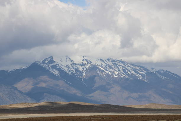 istock Snow Capped Mountain Peaks Hidden in Clouds 2166694085
