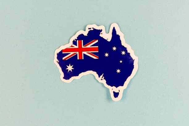 Australia Map Sticker with National Flag on Light Blue Background with Copy Space.