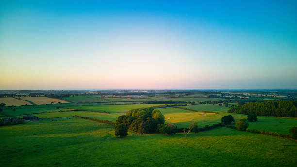 istock Serene landscape at dusk with lush green fields and a clear horizon under a soft gradient sky in Yorkshire. 2166699959