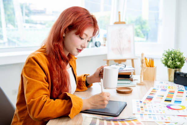 istock A creative and talented Asian female designer is working on her new project using a digital tablet. 2166700964
