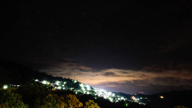 istock Village at night and stars. 2166702101