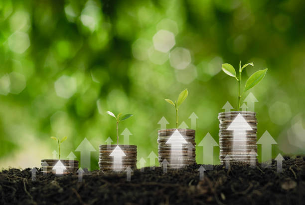 istock Green business growth or green investment and Finance sustainable development concept. Stack of silver coins the seedlings are growing on top with arrow of growth. Carbon credit, ESG, co2, green tax. 2166702193