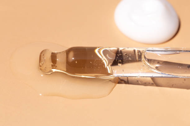 istock serum pipette close-up with falling drop on a beige background 2166703965