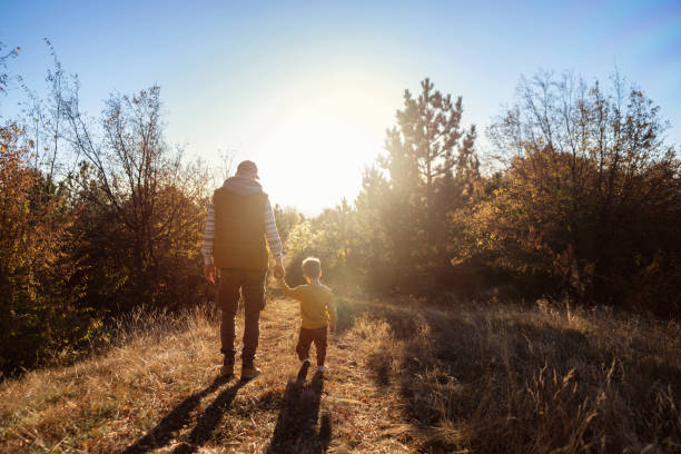istock Dad and son enjoying an autumn walk in nature 2166705146