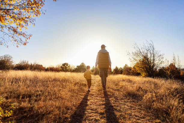 istock Dad and son enjoying an autumn walk in nature 2166705207