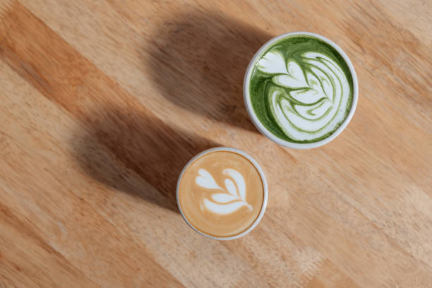 A cup of Latte and Matcha Latte on wooden table