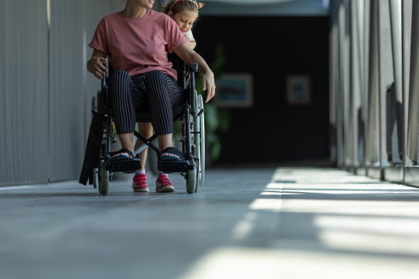 istock Little daughter helping her disabled mother 2166705369