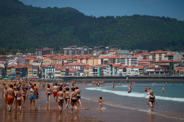 istock Serene Beachfront with Quaint Village in the Distance 2166705400