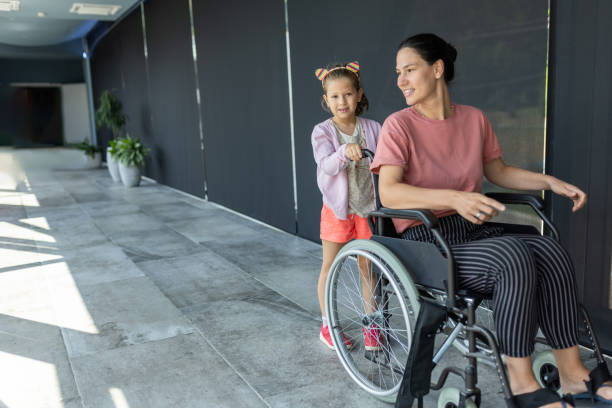 istock Little daughter helping her disabled mother 2166705481