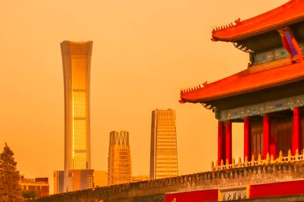 A striking contrast of Beijings architectural evolution, featuring the traditional structures of the Forbidden City alongside the modern skyscrapers of the citys Central Business District, including the iconic CITIC Tower, at sunset.