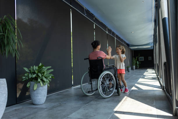 istock Mother and daughter having fun in hotel corridor 2166705937