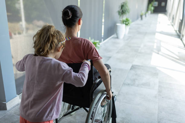 istock Little daughter helping her disabled mother 2166706018