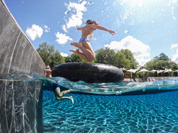 istock Kids having fun on swimming pool 2166706074