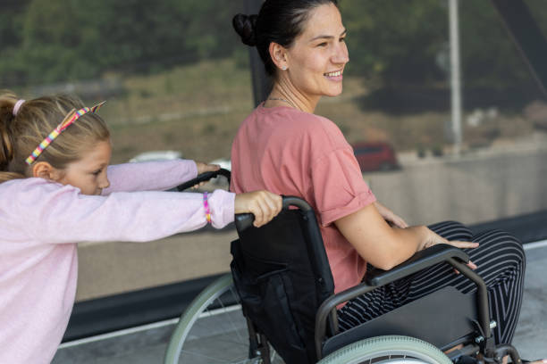 istock Little daughter helping her disabled mother 2166706334