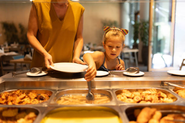 istock Mother and daughter choosing breakfast in hotel 2166706508