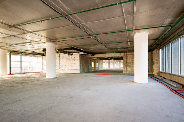 istock Free empty workspace for the office. A room in concrete without finishing 2166709105