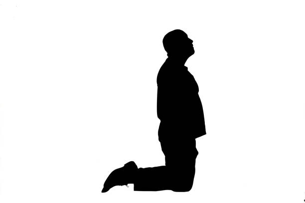 silhouette of a man kneeling on white background look up