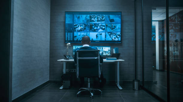 istock African American security worker controls CCTV cameras on computer and big digital screen 2166713986