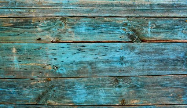 istock Panorama weathered wood old panel, aged, dilapidated cracked surface with grungy texture, flaking paint cyan hues. Decay, erosion decrepit plank or floorboard. Ancient board with chipped and peeling 2166714071