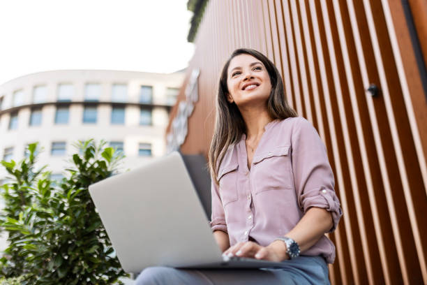 istock Businesswoman Working with Laptop Outside 2166715599