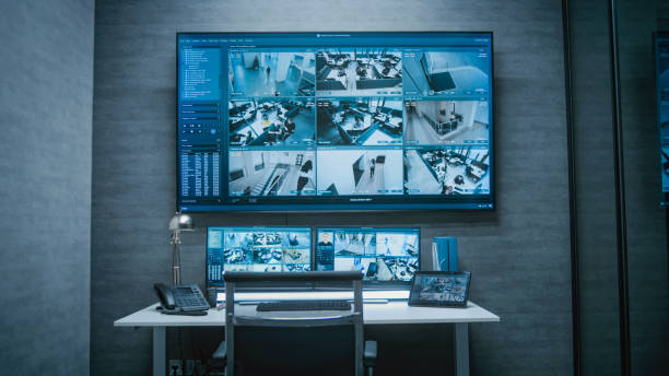 istock Computer monitors and big digital screen showing surveillance footage 2166715901