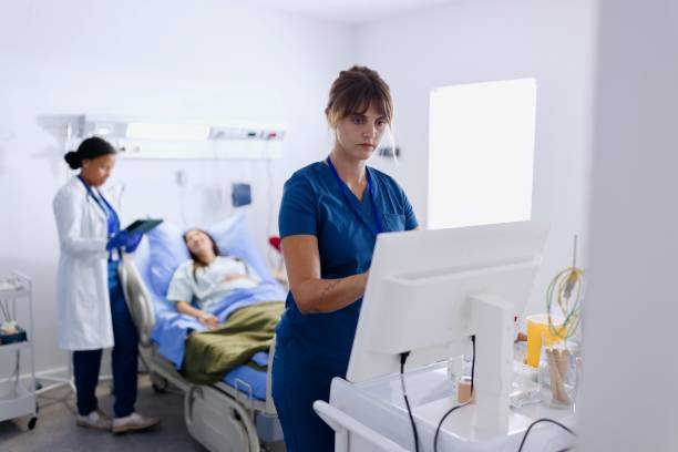 istock Modern nurse working on a computer during a patient's visit in the modern medical clinic 2166718542