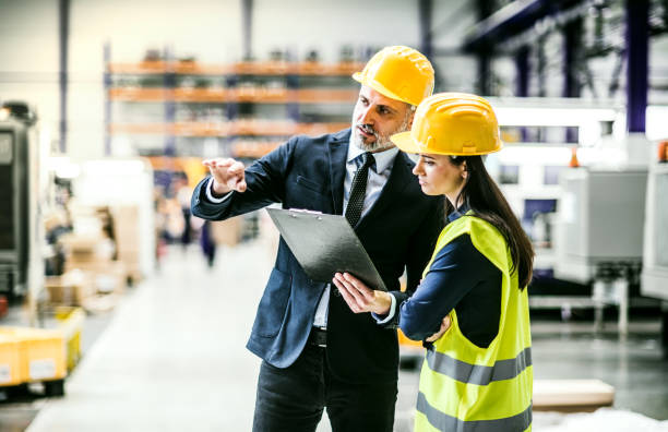 istock Warehouse worker shaking hand with logistics employee in warehouse, planning transport of products, goods, talking shipping process. 2166718569