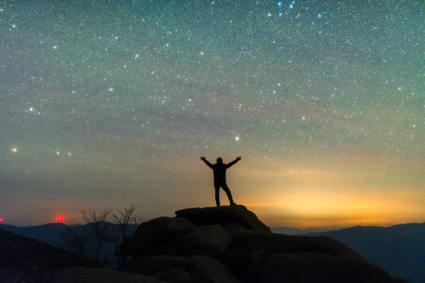 istock Dreamy sky and people looking up at the stars 2166718648