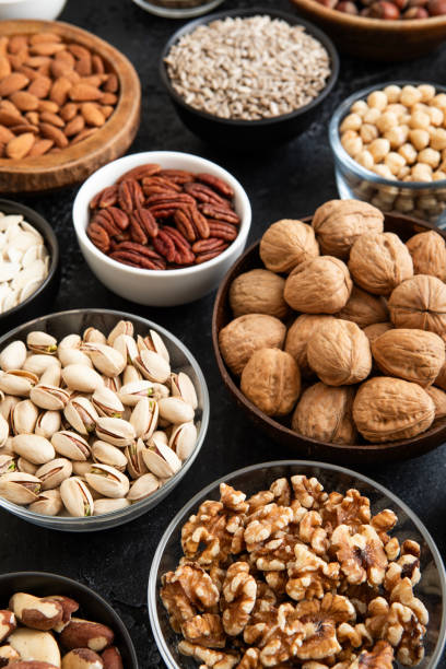 istock Raw walnuts and cashew with almonds and peanuts with organic nuts and seed in various assorted bowls.Macro 2166719582