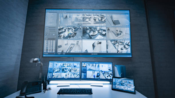istock Surveillance footage displayed on computer monitors and big digital screen 2166721364