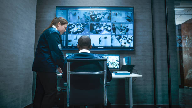 istock African American security worker controls CCTV cameras on computer and big digital screen 2166722611