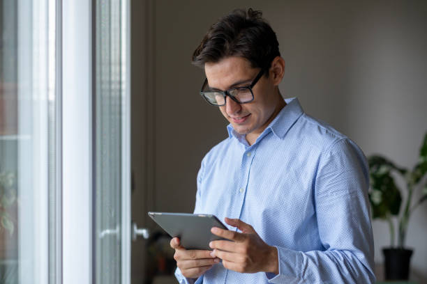 istock Portrait of young man using digital tablet at home 2166723235