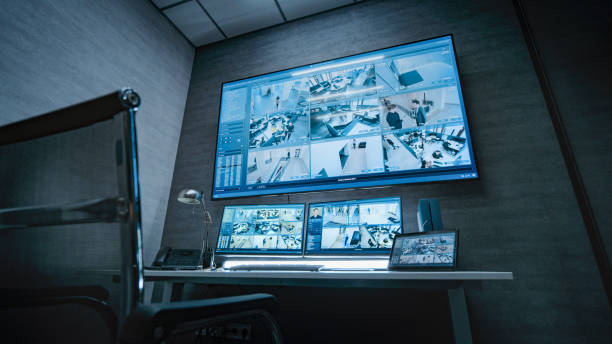 istock Surveillance footage displayed on computer monitors and big digital screen 2166723307
