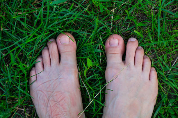 istock A person standing barefoot on green lawn grass 2166726342