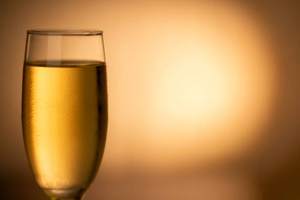 istock Chilled champagne glass on the left side, sparkling against a golden gradient background. Ideal for New Year’s Eve and Christmas celebrations. 2166726878