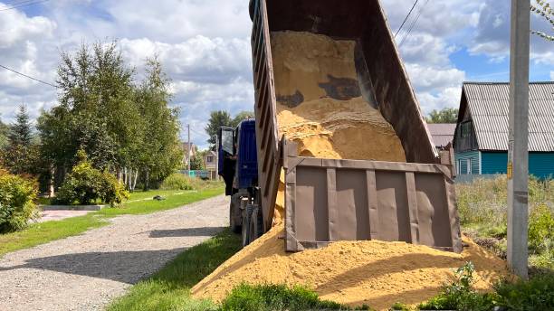 istock A truck brought sand for the construction site. Bulk cargo delivery. unloading process 2166727253