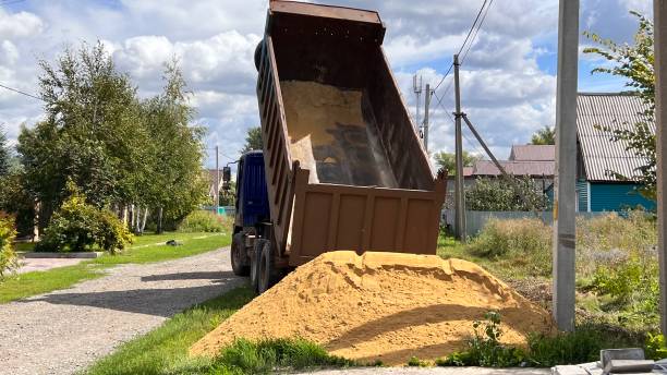 istock A truck brought sand for the construction site. Bulk cargo delivery. unloading process 2166727254