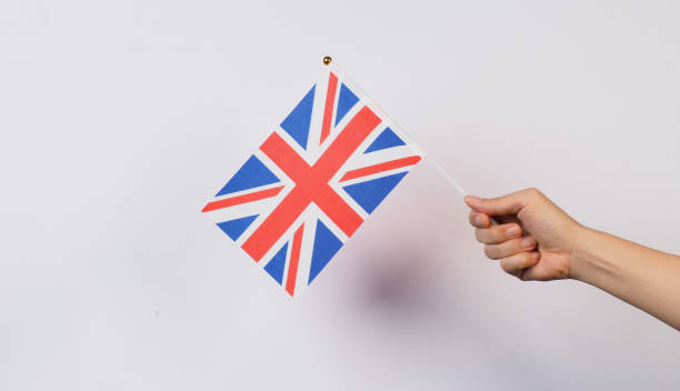 istock Hand is holding Union Flag or Union Jack on white background 2166727271