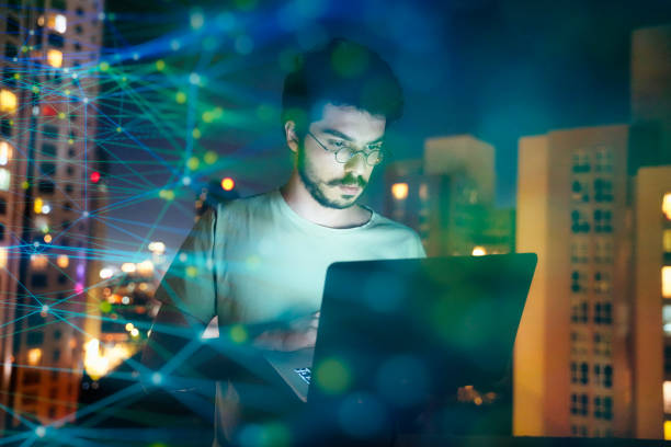 istock Focused Man Using Laptop with Digital Connections in the Background 2166728553