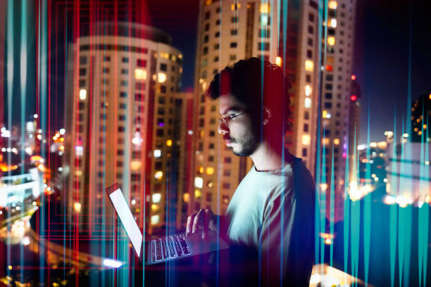 istock Man Typing on Laptop with Vertical Light Beams 2166728874