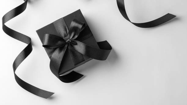 istock Black friday concept, gift box with black ribbon on white background, top view 2166730346