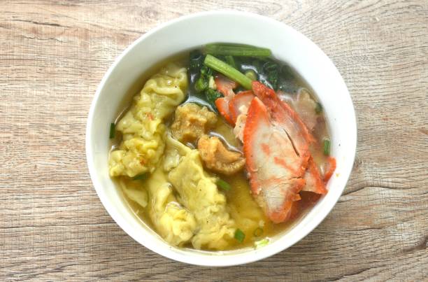 istock Chinese dumpling topping slice red barbecue pork and cabbage in clear soup 2166733349