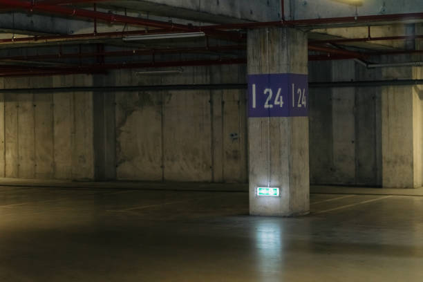 istock Parking lot with overhead dim light, underground parking garage 2166733387